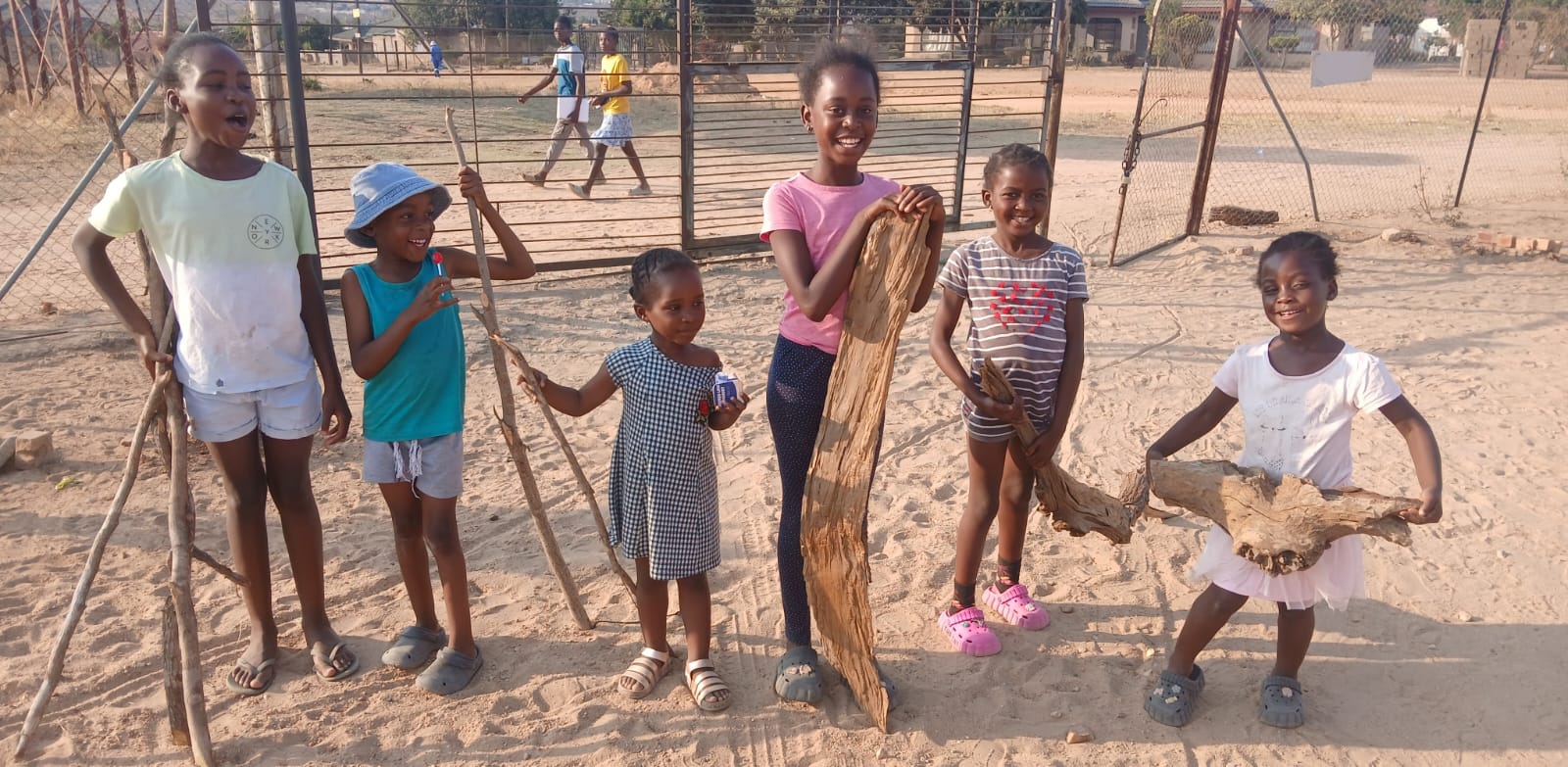 kids carrying firewood