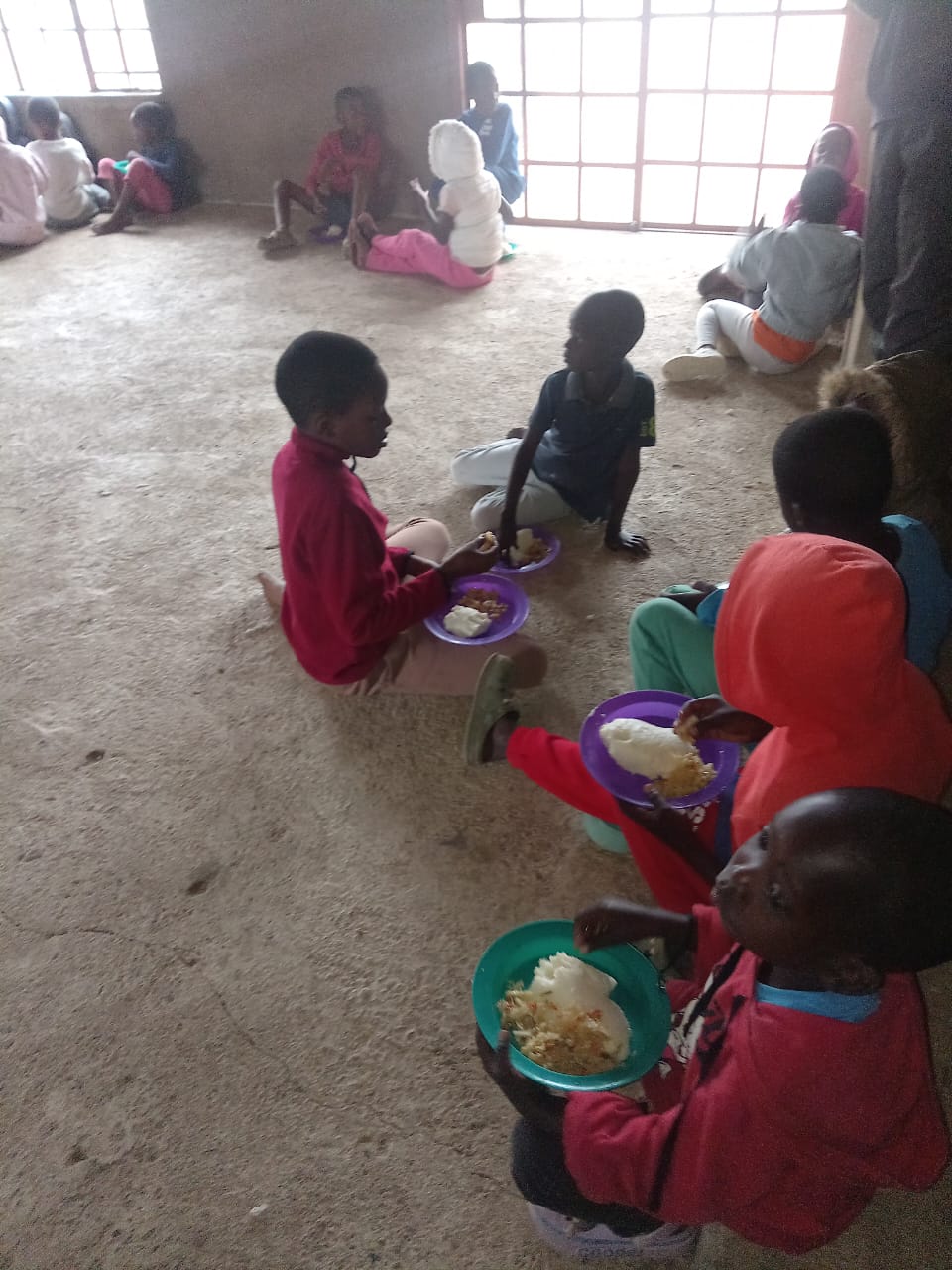 Feeding children at NOMAGOM