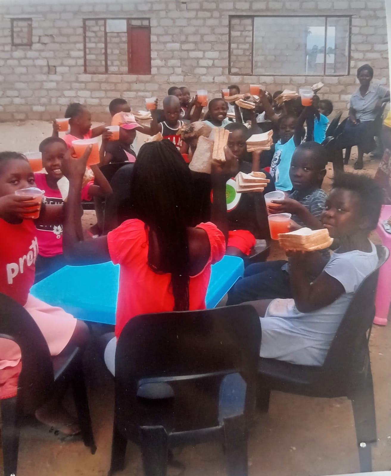 Smiling children after receiving help from NOMAGOM program